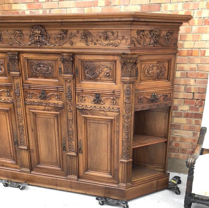 WALNUT GRIFFIN CARVED CABINET WITH CANTED ENDS