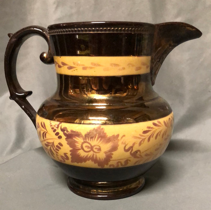 COPPER LUSTER MEDIUM PITCHER WITH 2 ORANGE BANDS & PURPLE FLOWERS