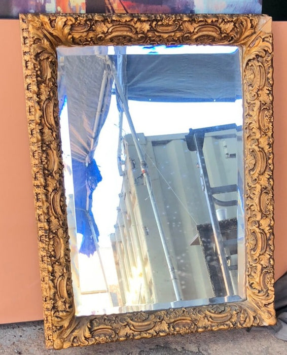 BEVELED GLASS MIRROR IN ORNATE GILT FRAME