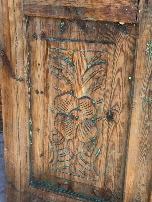 PAIR OF PINE DOORS WITH CARVED FLOWERS AND PARTIAL GREEN PAINT