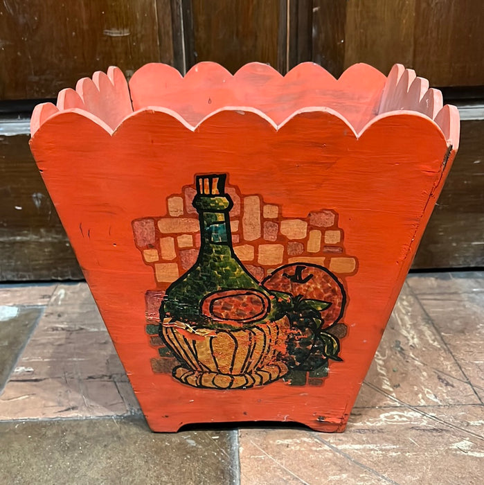 ORANGE PAINTED WOOD TRASH CAN WITH OLD WINE BOTTLE