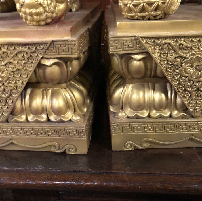 PAIR OF GILT FOO DOG SCULPTURES ON STANDS