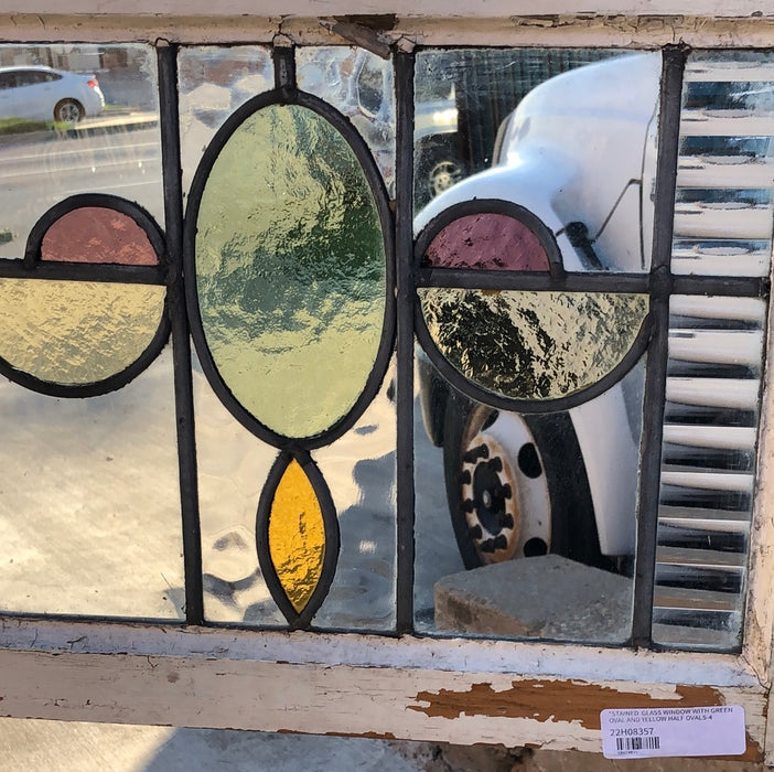 STAINED GLASS WINDOW WITH GREEN OVAL AND YELLOW HALF OVALS