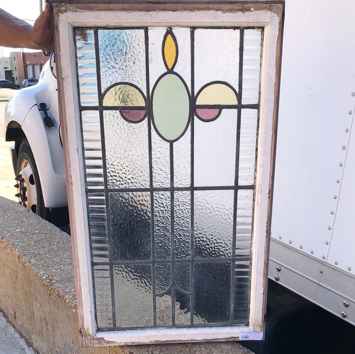 MEDIUM VERTCAL STAINED GLASS WINDOW WITH GREEN OVAL AND YELLOW HALF OVALS