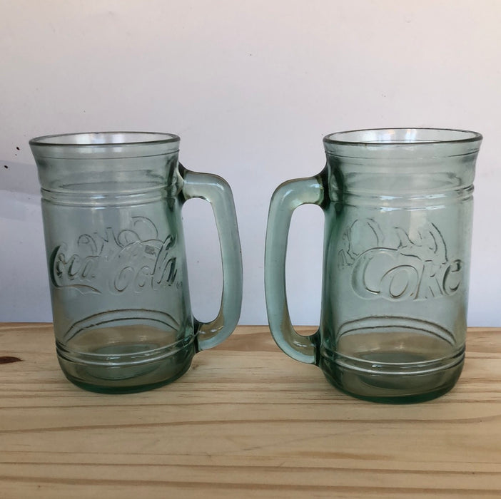 Pair of green glass Coca-Cola mugs