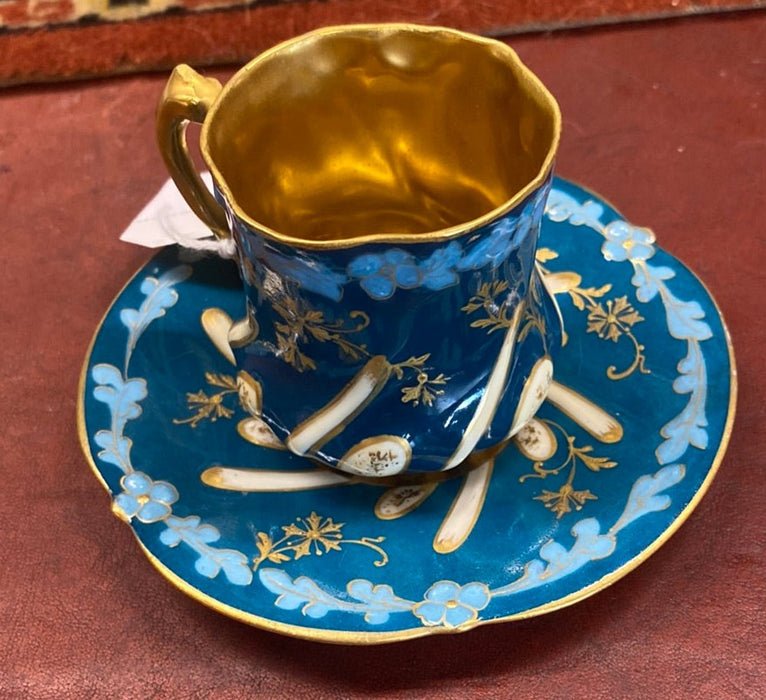 BLUE, GOLD, AND WHITE DEMITASSE CUP AND SAUCER