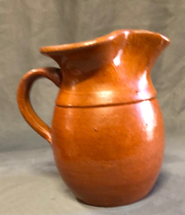 SMALL HAND THROWN ORANGE POTTERY PITCHER