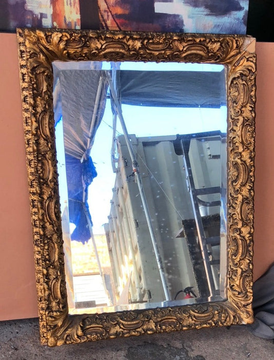 BEVELED GLASS MIRROR IN ORNATE GILT FRAME