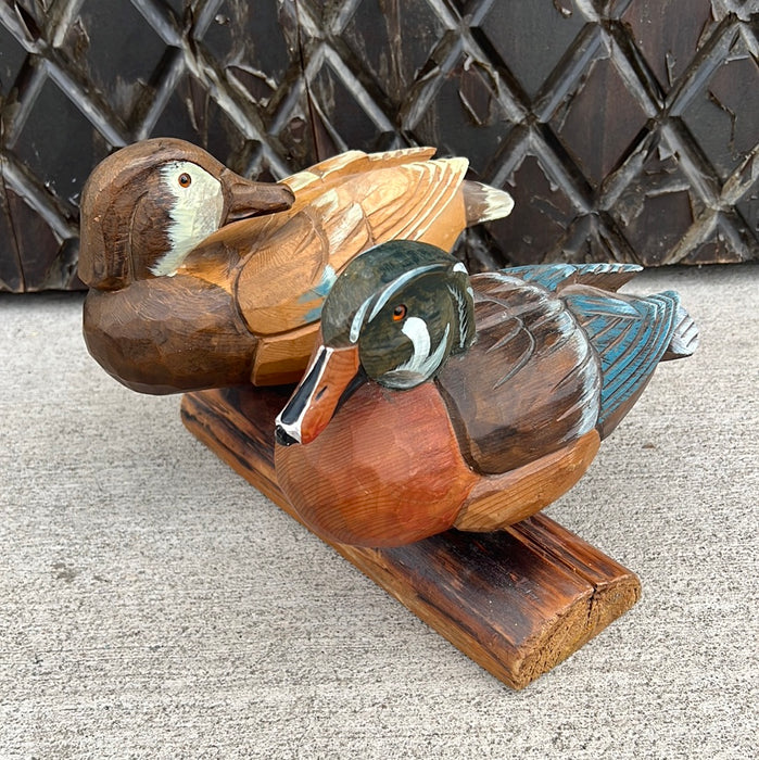 CARVED DUCKS ON LIMB