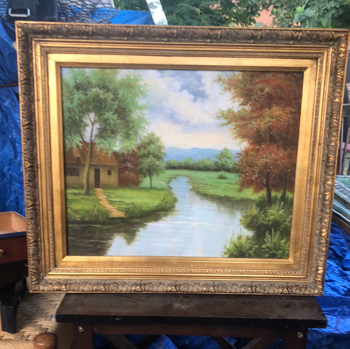 GILT FRAMED LANDSCAPE PAINTING ON CANVAS WITH YELLOW HOUSE