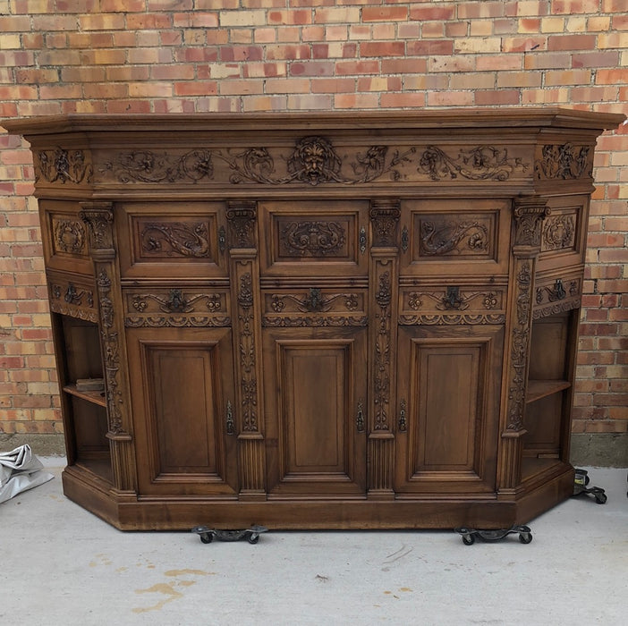 WALNUT GRIFFIN CARVED CABINET WITH CANTED ENDS