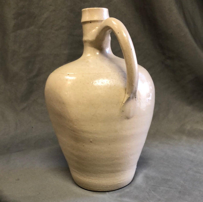 HAND THROWN WHITE POTTERY JUG WITH FLAT SIDES AND HANDLE