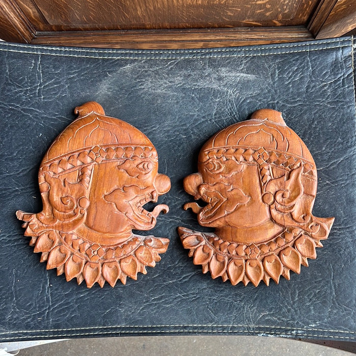 PAIR OF ASIAN HAND CARVED PROFILE PLAQUES WITH TONGUES OUT