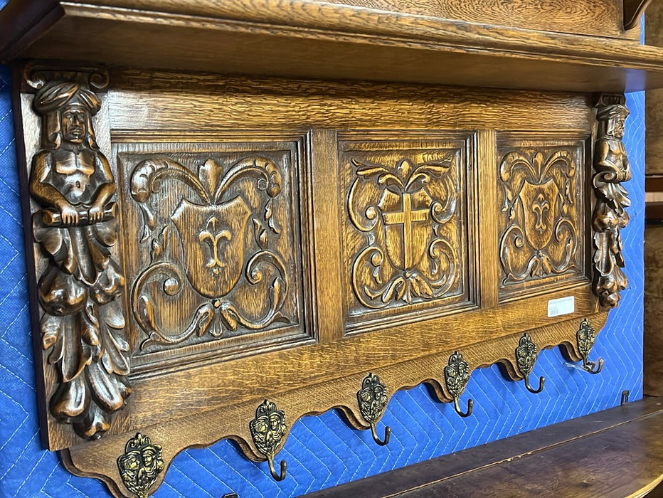 OAK CROSS AND FIGURAL CARVING WALL SHELF WITH HOOKS