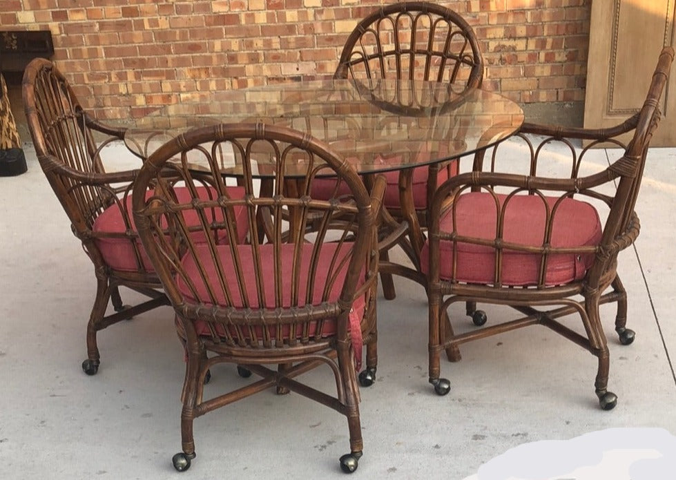 SET OF GLASS TOP RATTAN TABLE AND 4 MATCHING CHAIRS ON CASTERS