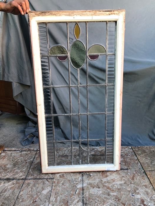 TALL STAINED GLASS WINDOW WITH GREEN OVAL AND YELLOW HALF OVALS