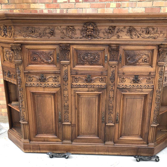 WALNUT GRIFFIN CARVED CABINET WITH CANTED ENDS