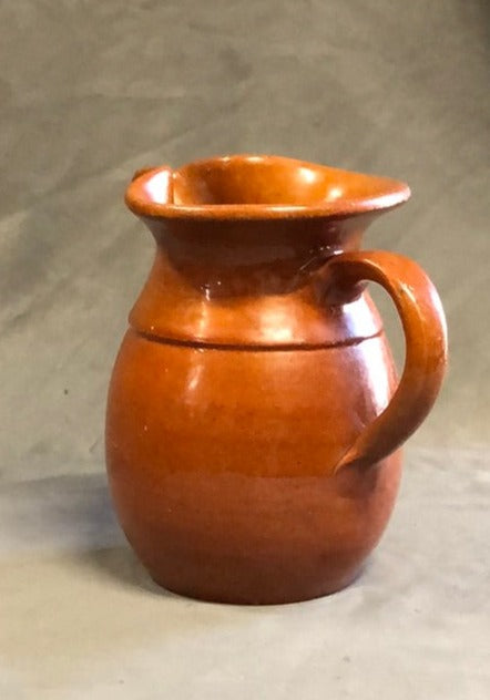 SMALL HAND THROWN ORANGE POTTERY PITCHER